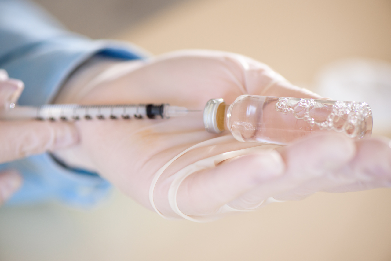 A doctor injecting insulin