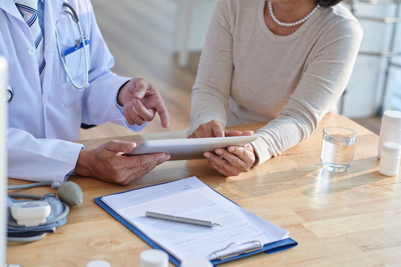Close up of a doctor and an elderly woman patient in an appointment