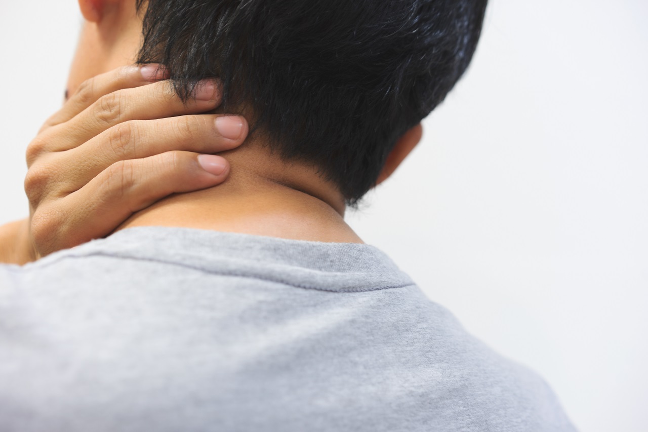 Close up of a man touching his neck due to pain