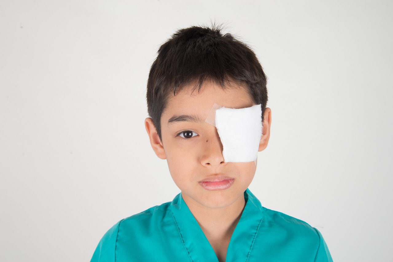 A young boy with an eye patch bandage