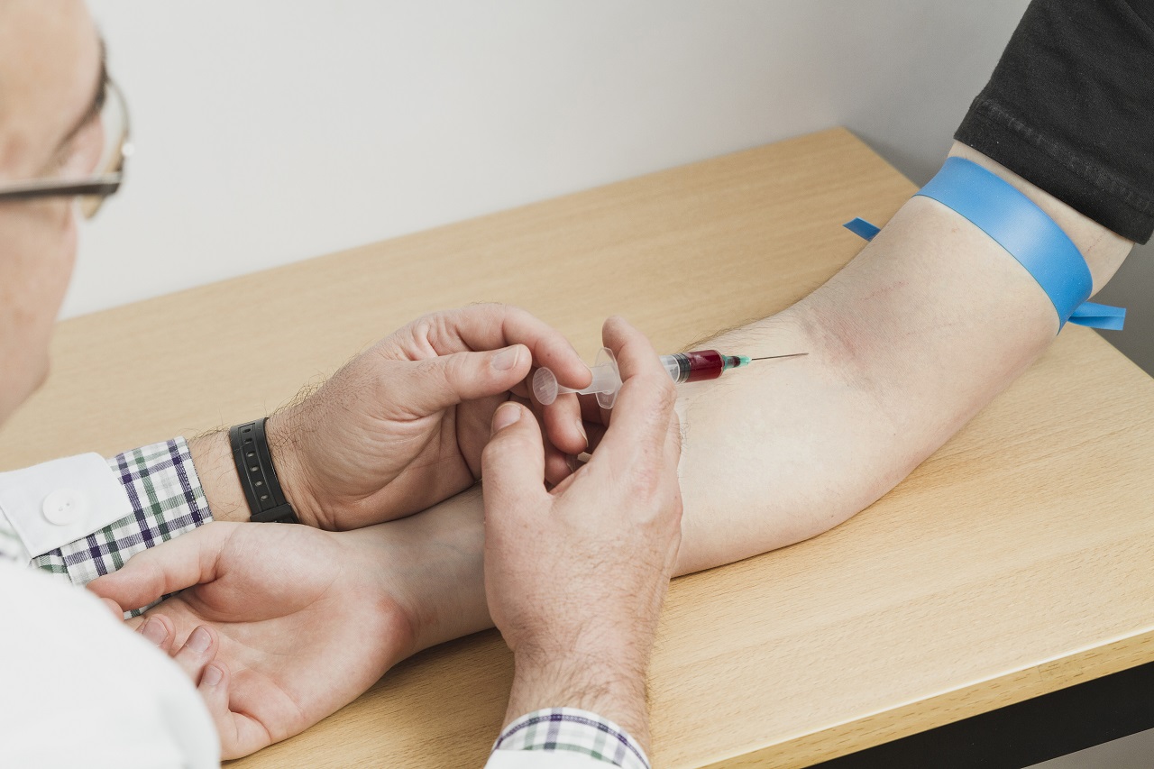 A doctor taking a blood sample