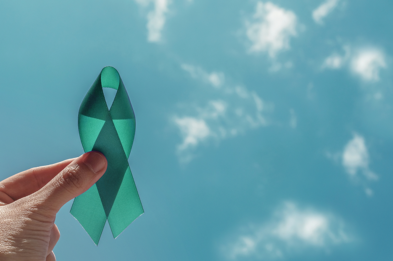 A teal ribbon signifying fight against cervical cancer
