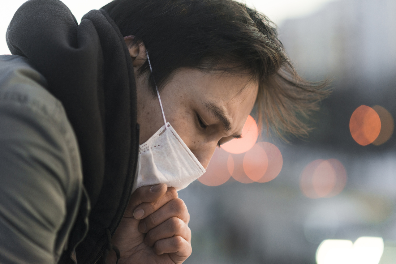 Close up of a man with pneumonia coughing