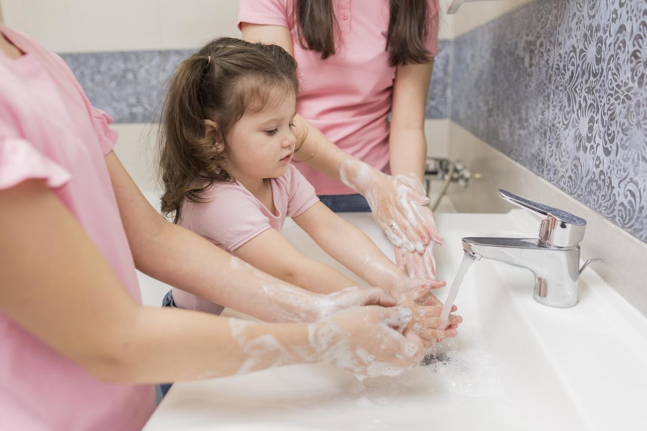 A little girl washing her hands