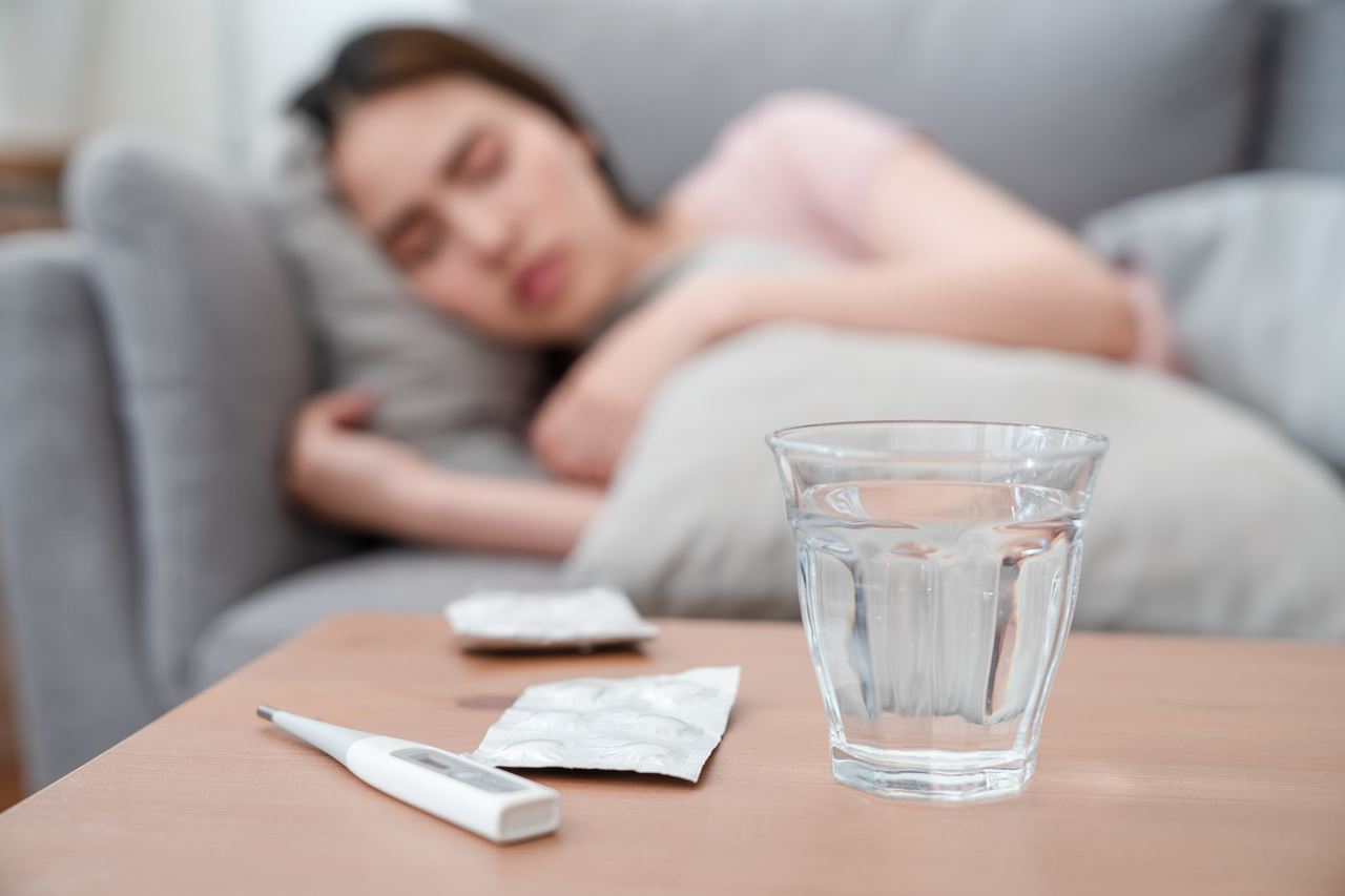 A woman self-medicating mild COVID-19 symptoms at home