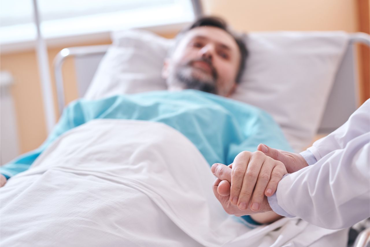 Doctor holding hand of patient